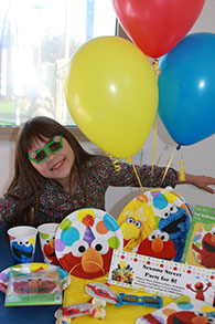 Young girl having fun at a Elmo Birthday Party.