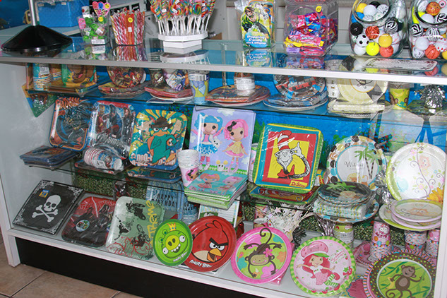 Party Supplies photo of a variety of party supplies available for sale at the store next to Emerald Dolphin.