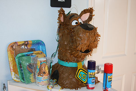 photo showing a scooby doo pinata, and party supplies along with silly string for a party.