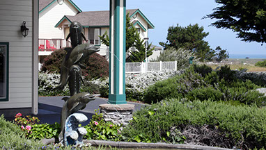 Entrance to Emerrald Dolphin Inn Fountain and shrubs at the front entrance of Emerald Dolphin Inn.