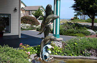 Emerald Dolphin Fountain photo of the sculptured Dolphins Fountain in front of Emerald Dolphin Inn.