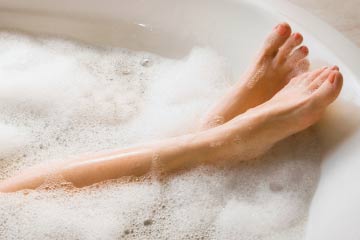 a photo of someone relaxing in a bubble bath.
