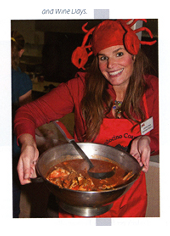 photo of a woman holding a dish at the crab and wine festival.