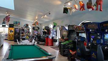 photo of the game room at Ed's Arcade. Showing pool table and video games.