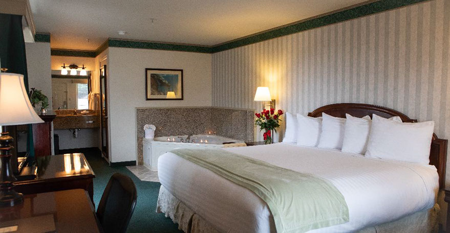 European King Size Bed European King Size Bed guest room. Photo showing King Bed, Jacuzzi Tub, Writing Desk with lamp and phone.