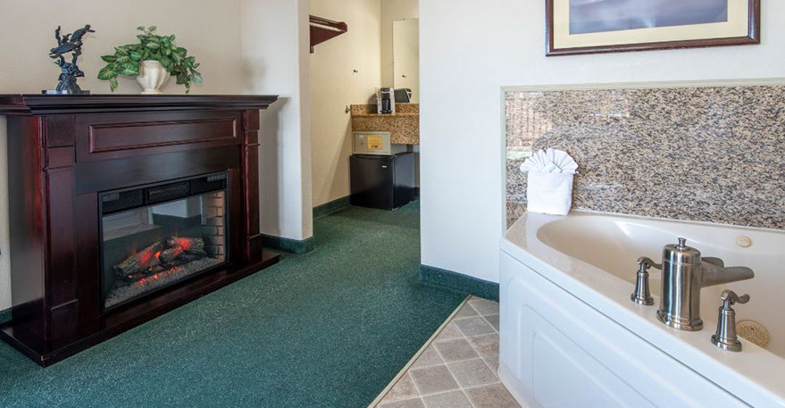 European King Size Bed European King Size Bed guest room. Photo showing King Bed, Jacuzzi Tub, Writing Desk with lamp and phone.