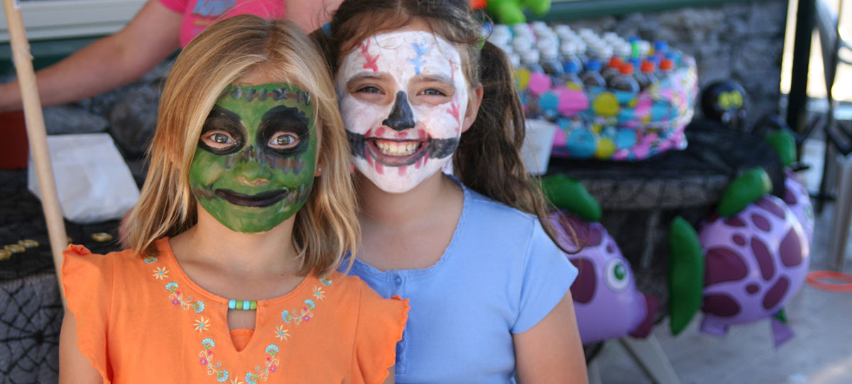 Speical Events photo of 2 girls with painted faces at a special event for halloween.