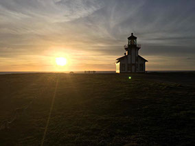 photo showing one of the light houses near Fort Bragg in a beautiful sunset background.