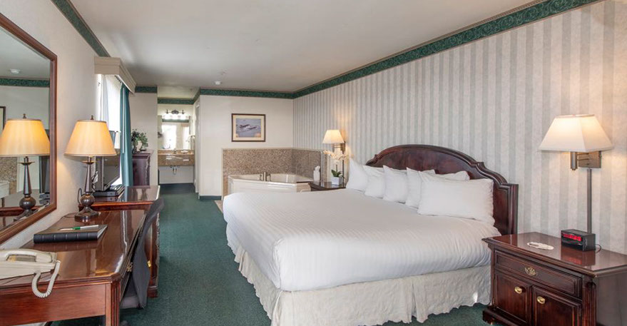 European King Size Bed European King Size Bed guest room. Photo showing King Bed, Jacuzzi Tub, Writing Desk with lamp and phone.