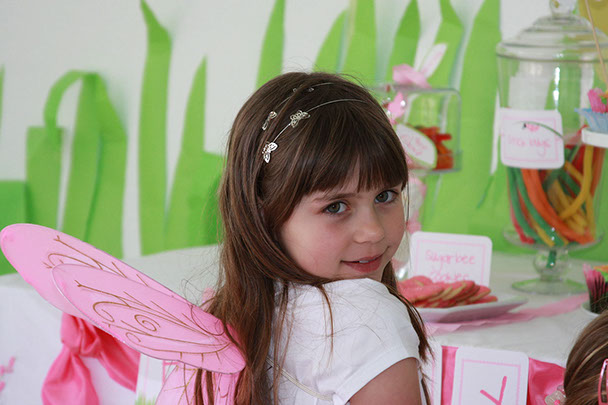 Party Supplies  photo of a young girl dressed in an outfit with wings and room decorated with pastels of pink, green with flowers.